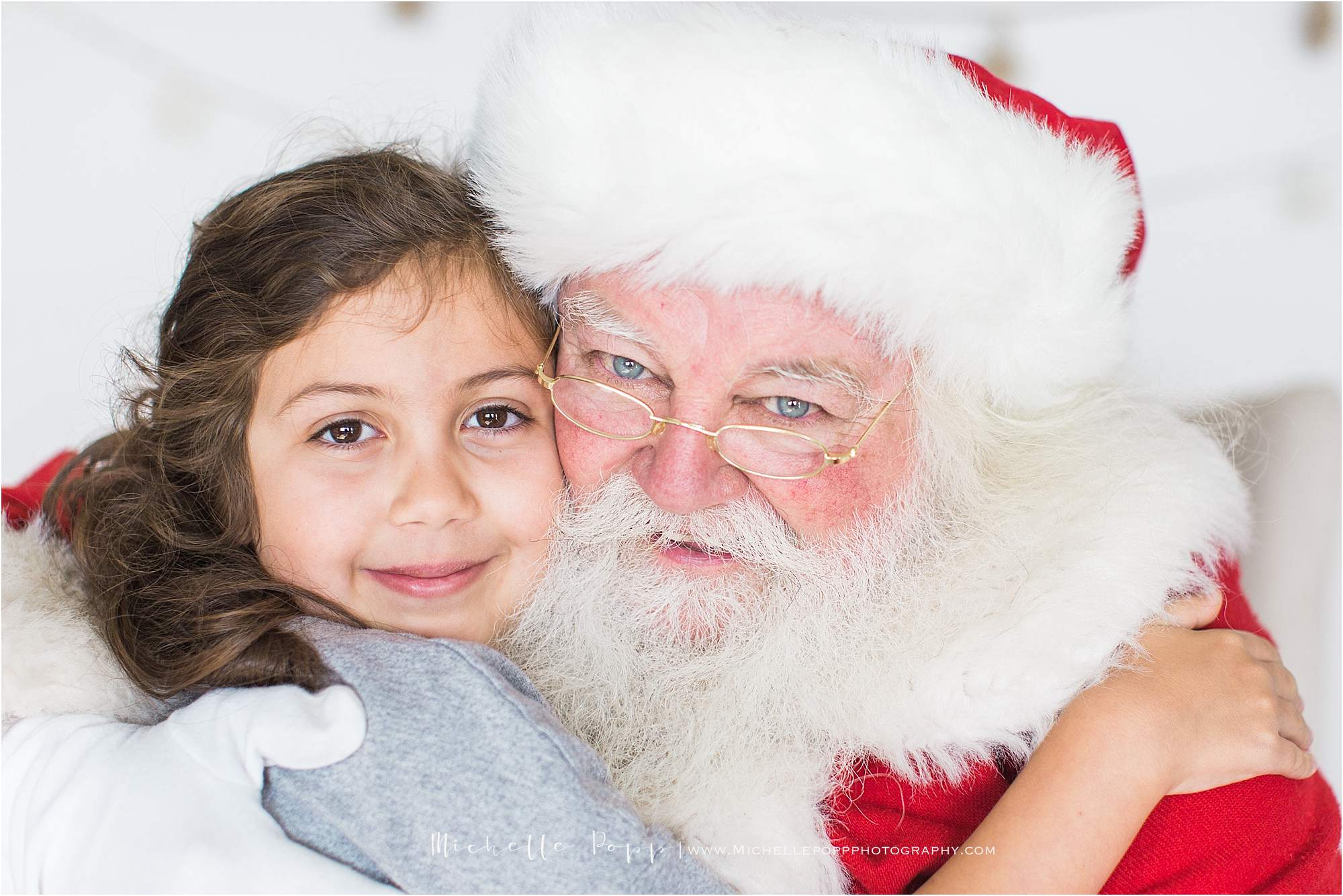 girl snuggling Santa