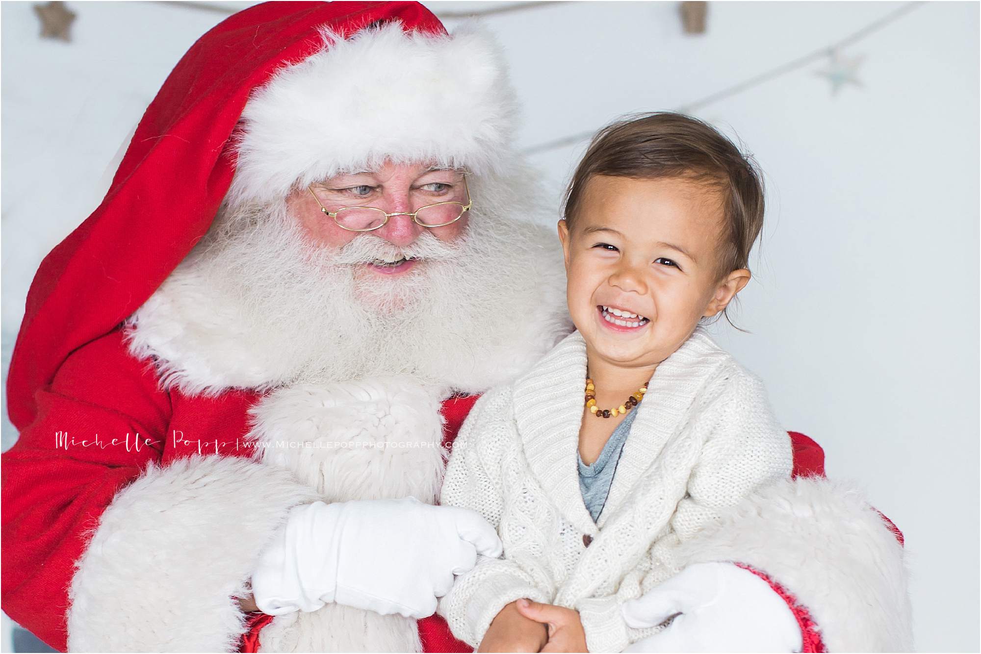 little boy smiling on Santa's lap