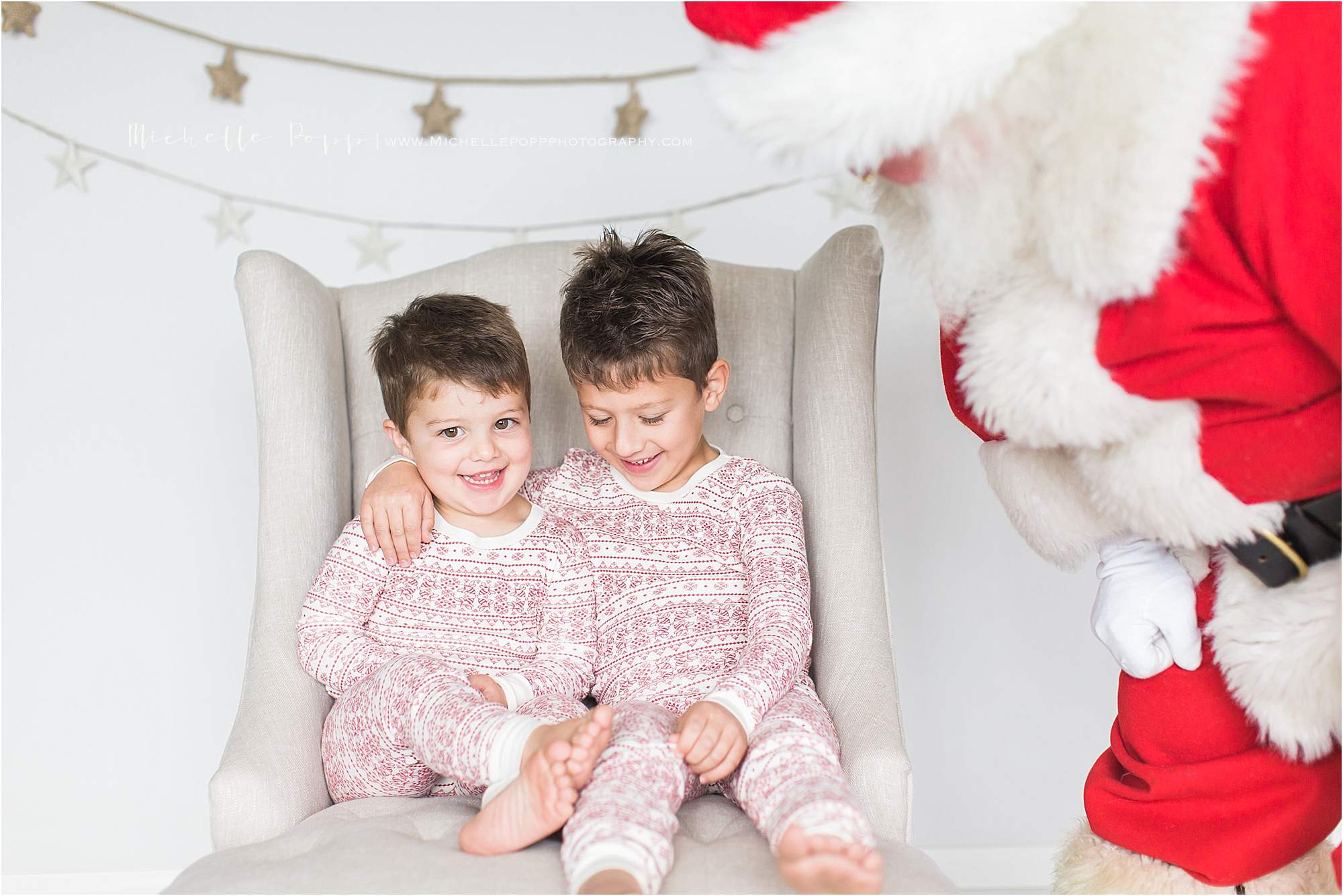 boys smiling next to Santa