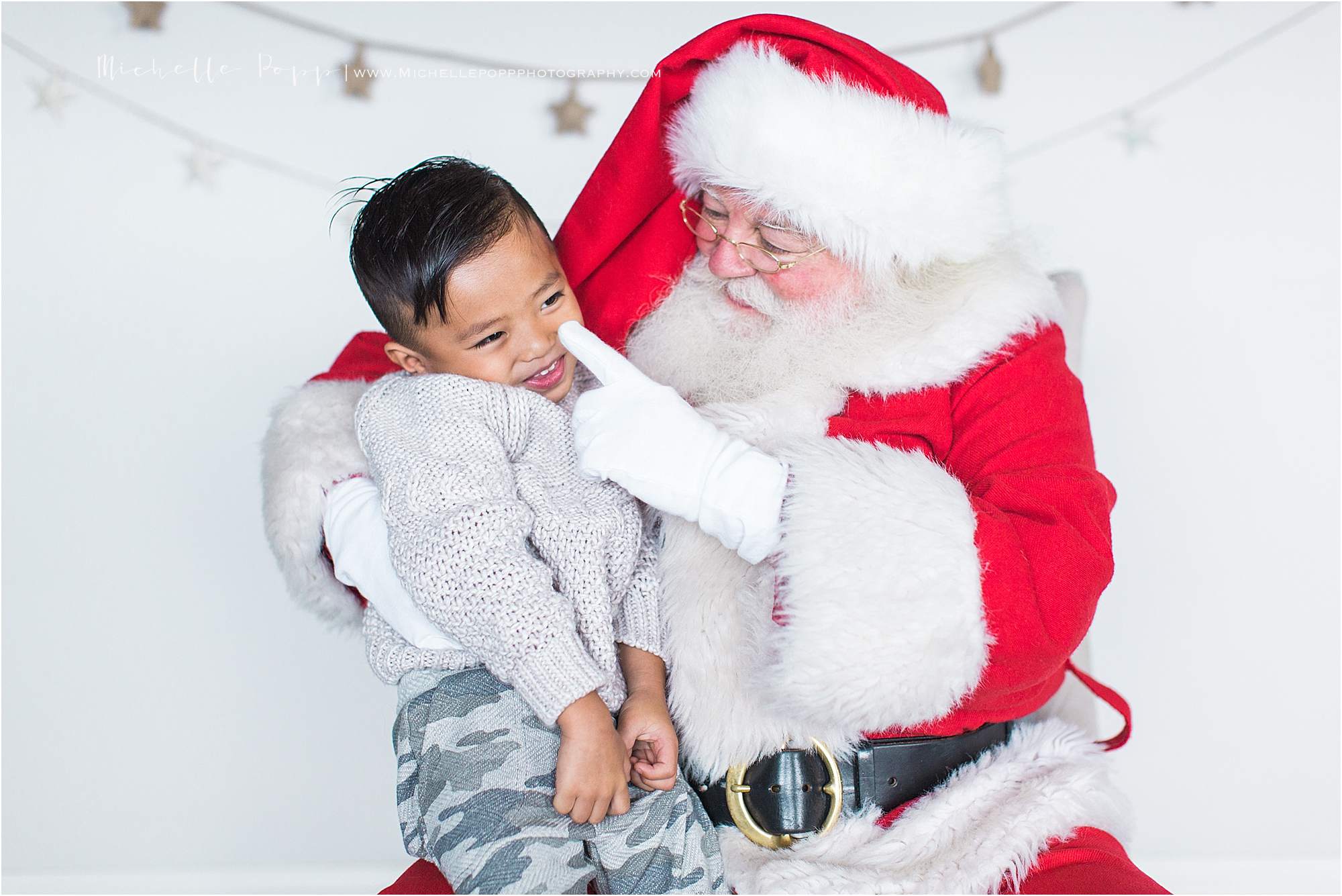 Santa touching little boy's nose