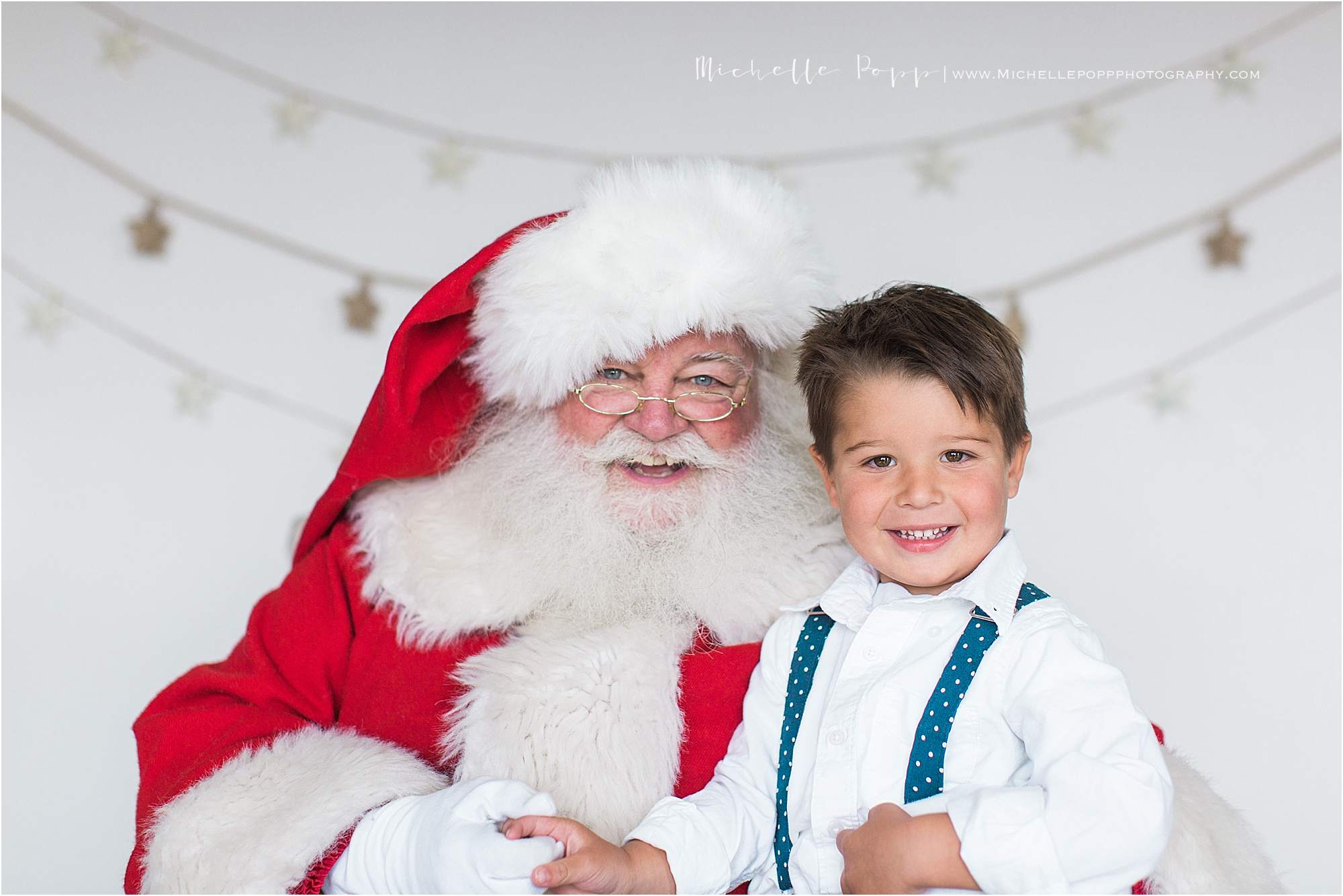 little boy smiling on Santa's lap