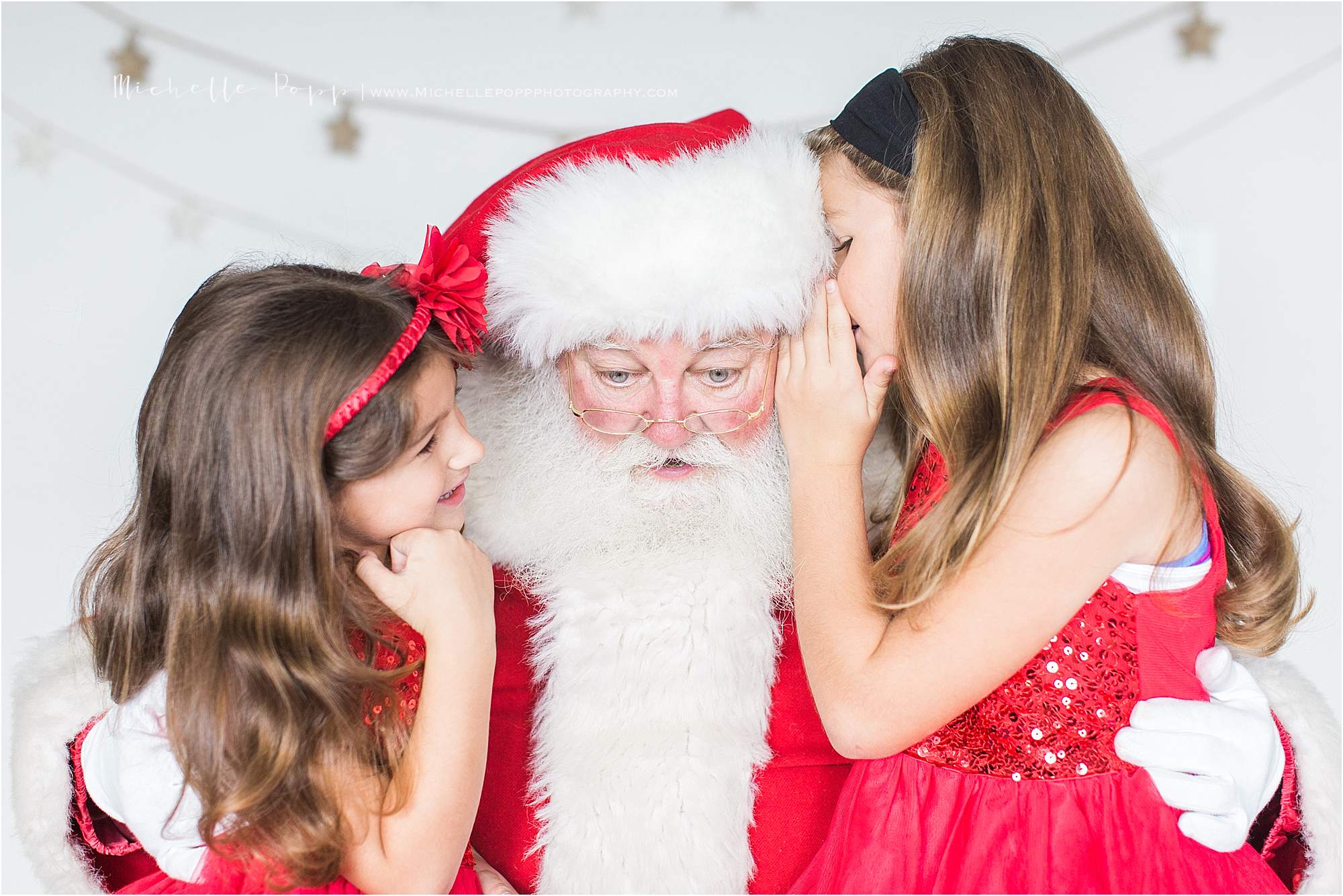 little girls whispering a secret to Santa