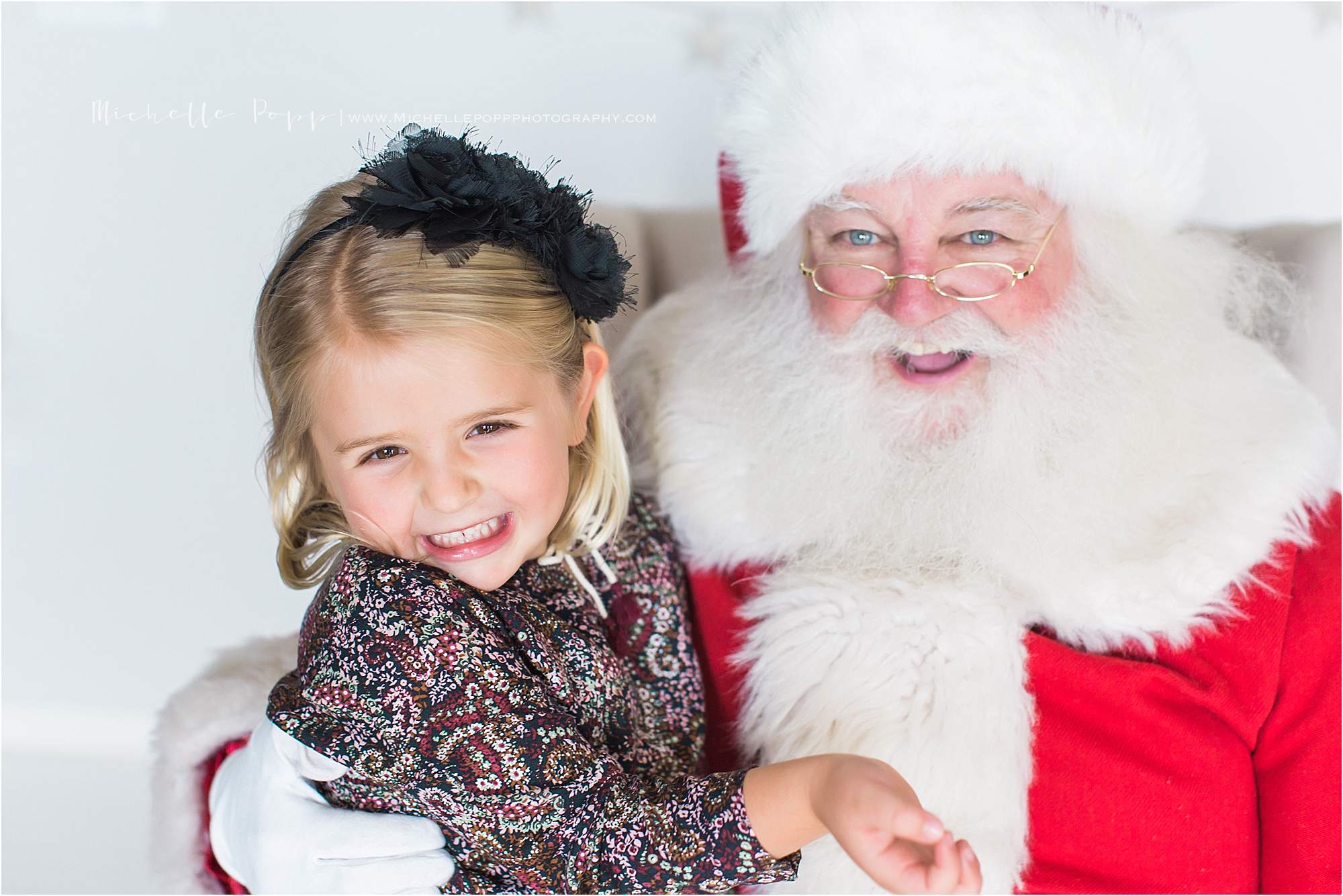 little girl with black bow smiling 