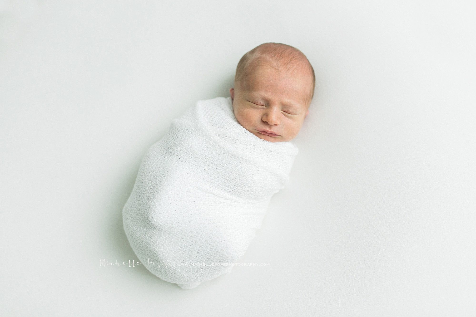 Baby in white swaddling 