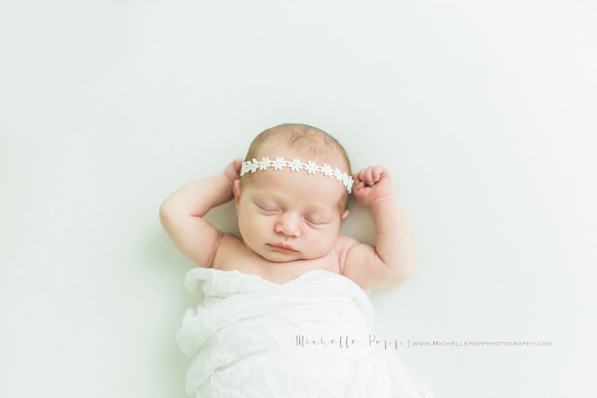 baby with white flower headband