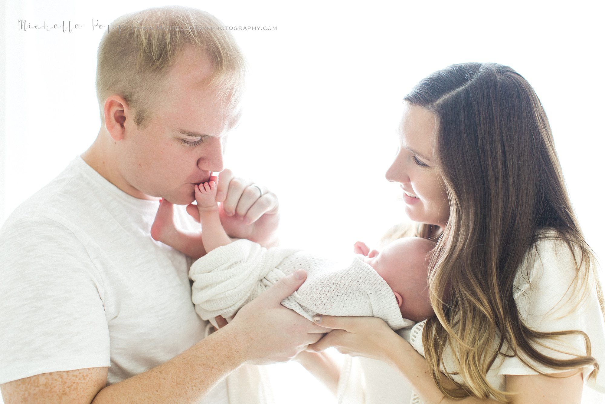 Dad kissing babies toes