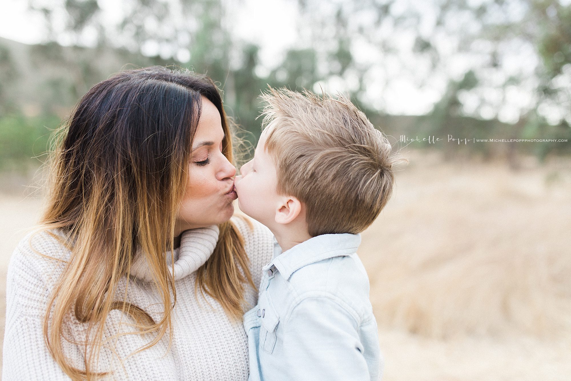 little boy kissing his mom