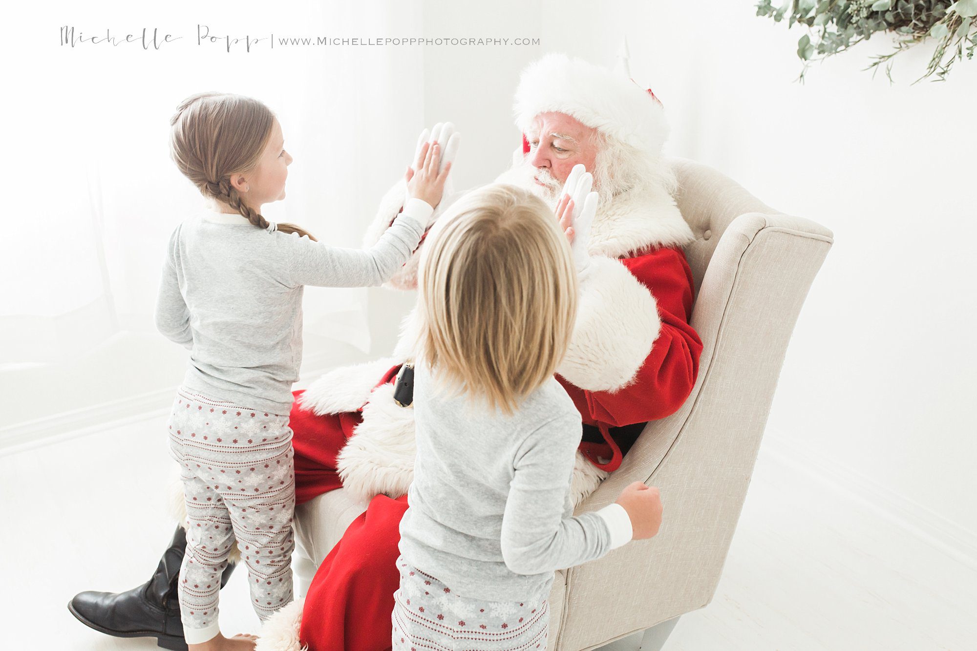 two kids high giving Santa