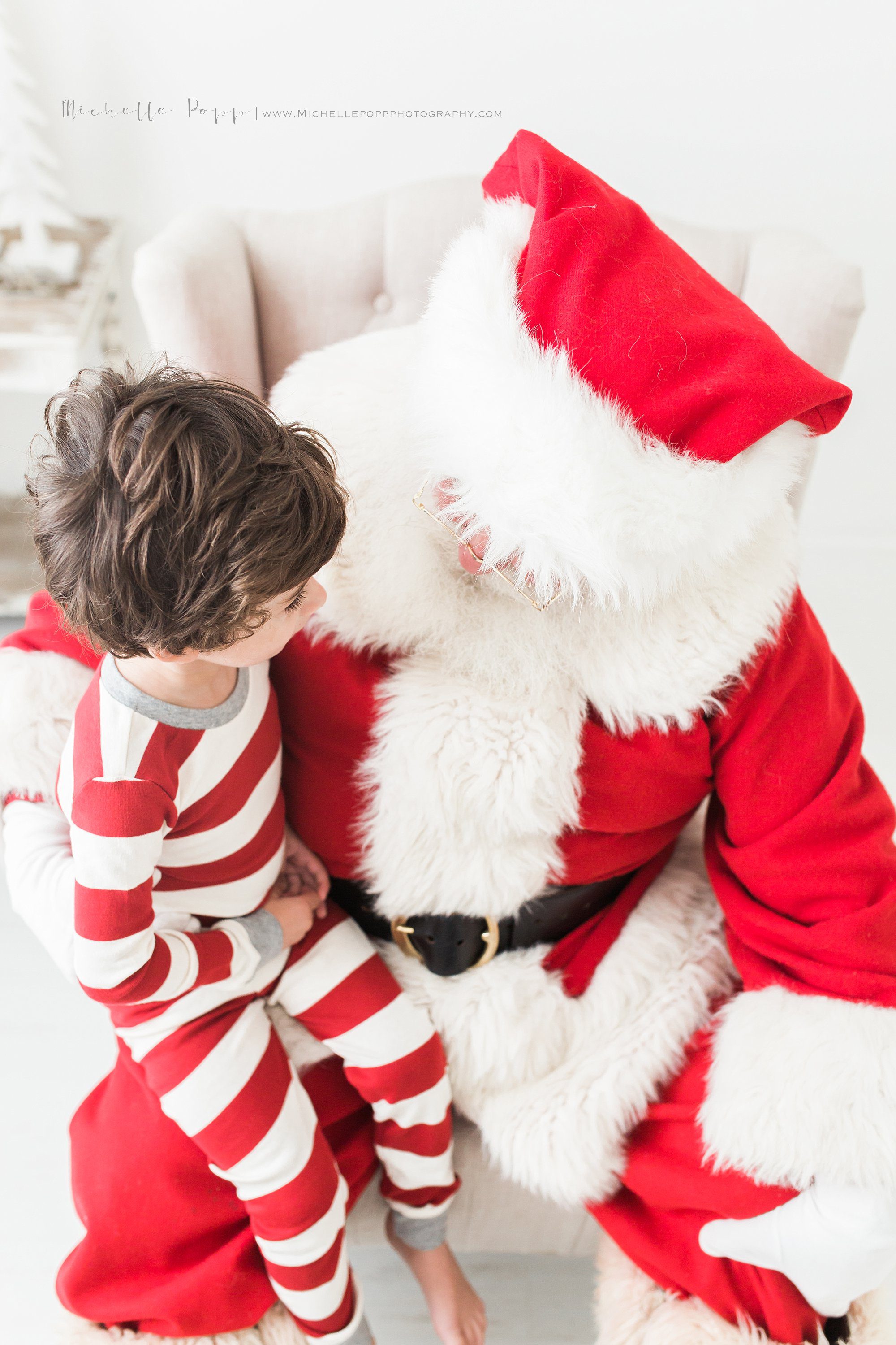 boy in pajamas on Santa's lap
