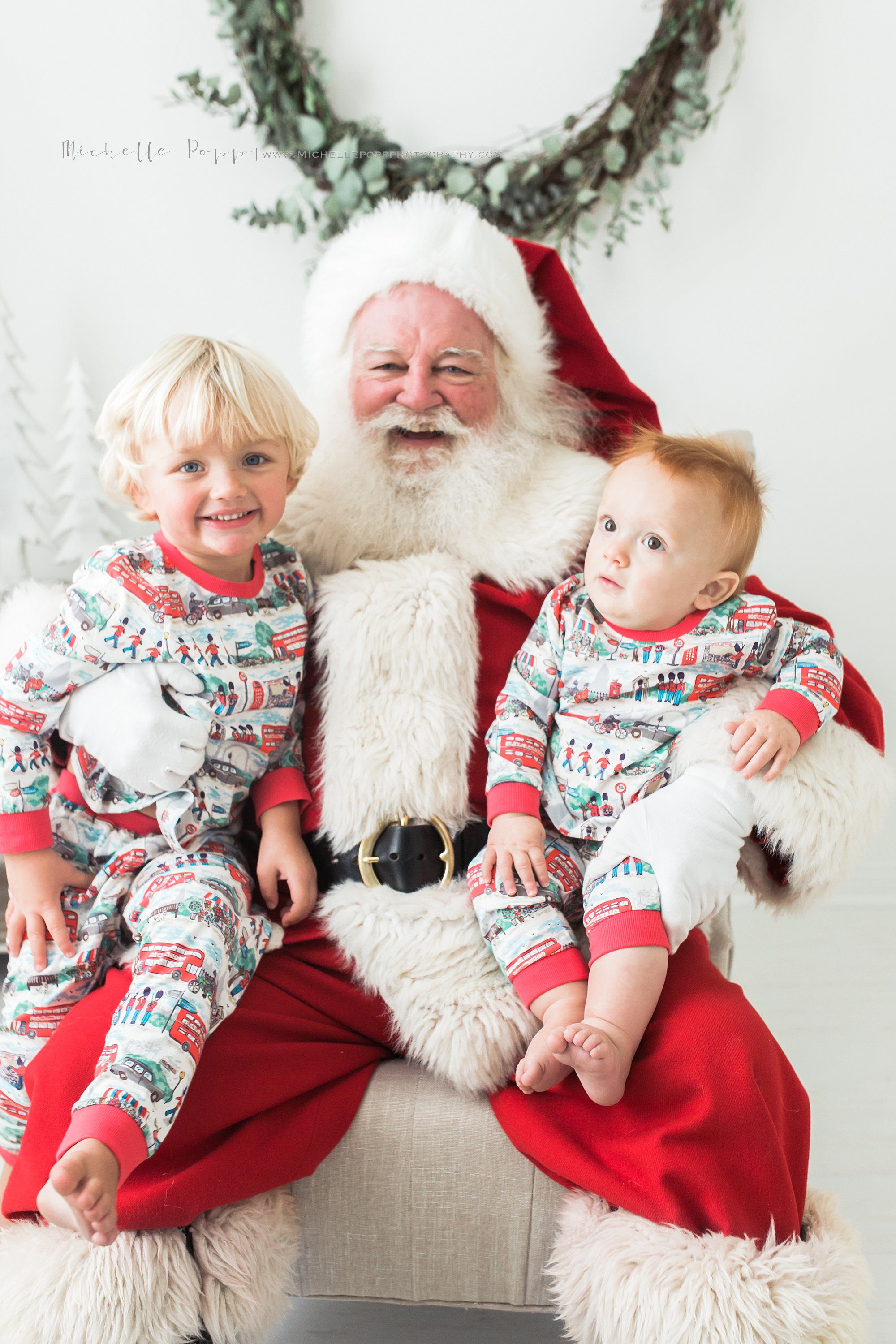 two little boys sitting on Santa's lap