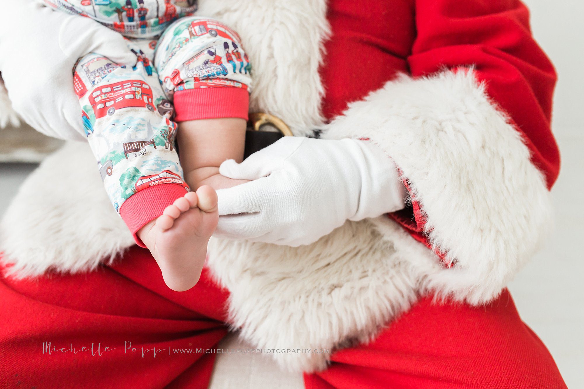 Santa holding babies foot