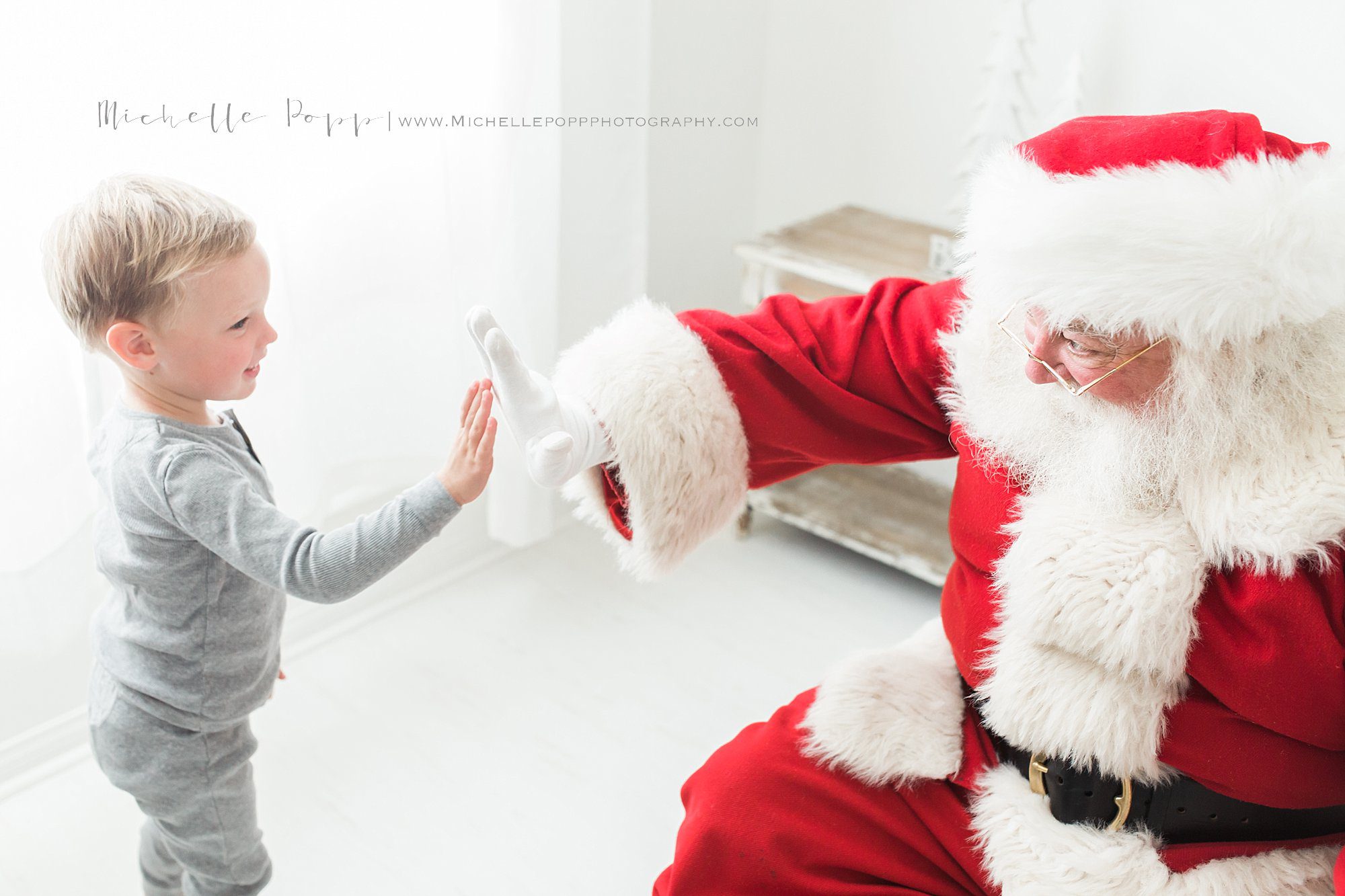 Santa giving little boy a high five