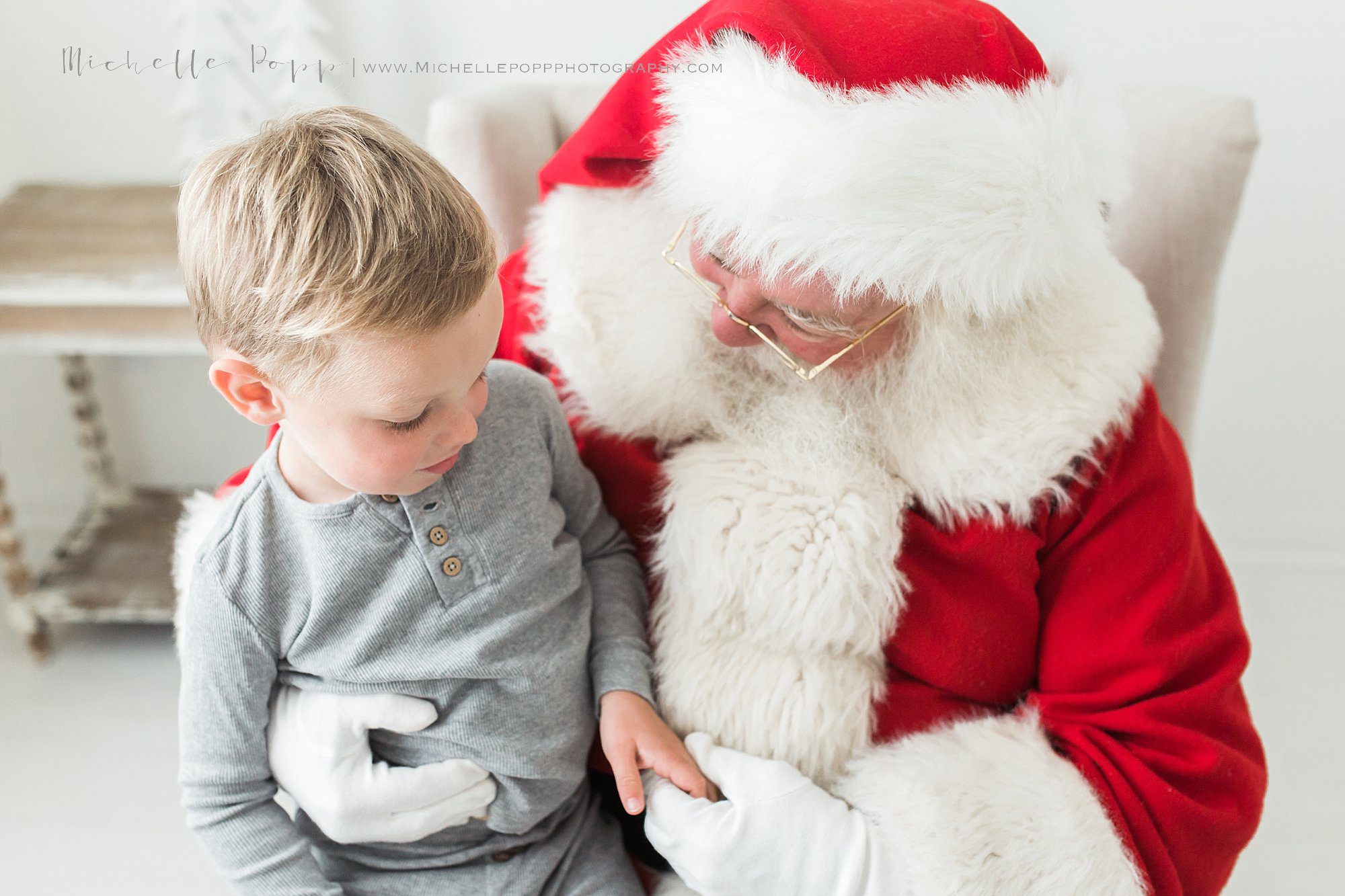 Santa holding little boys hand