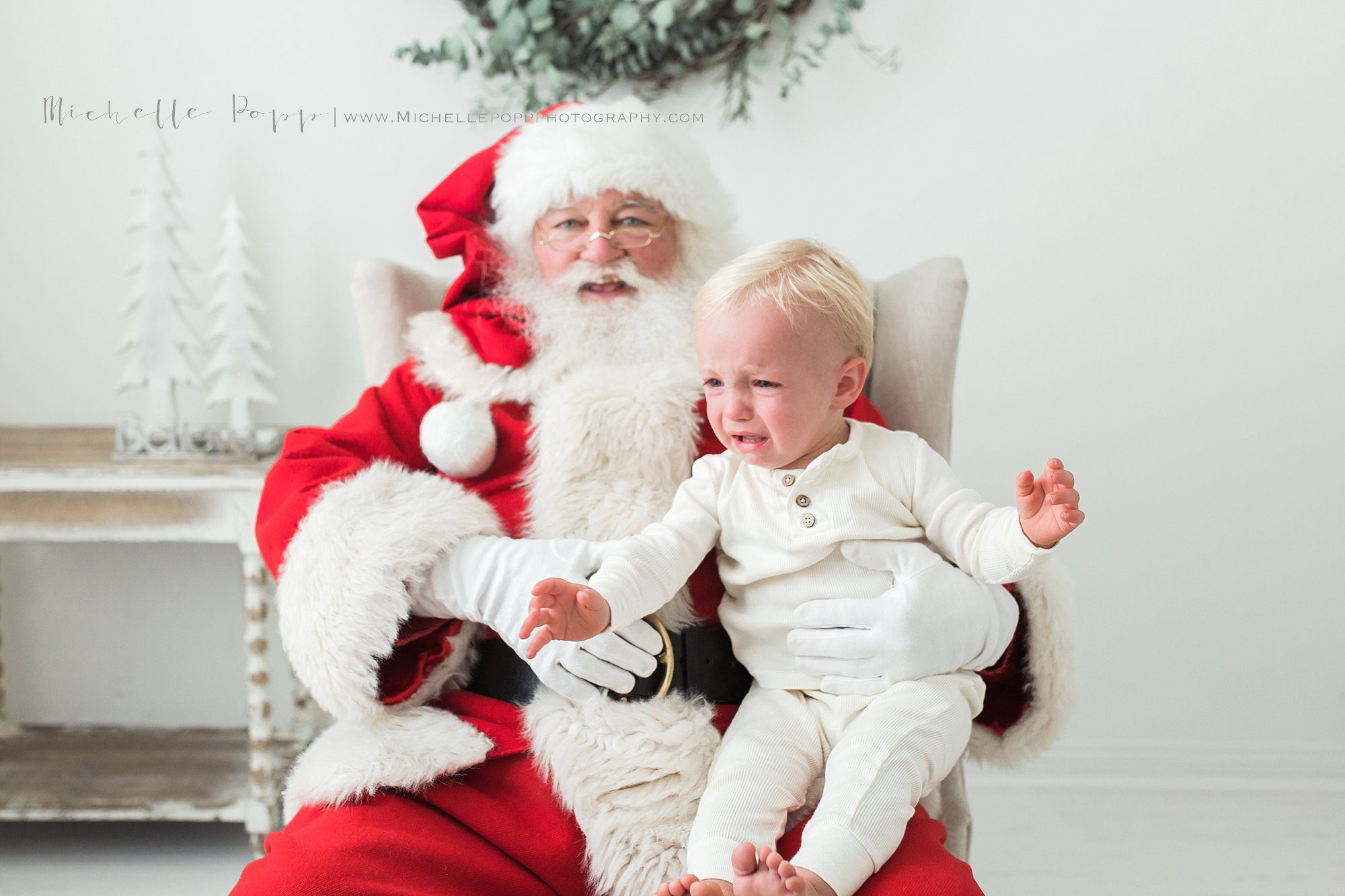 little boy crying on Santa's lap