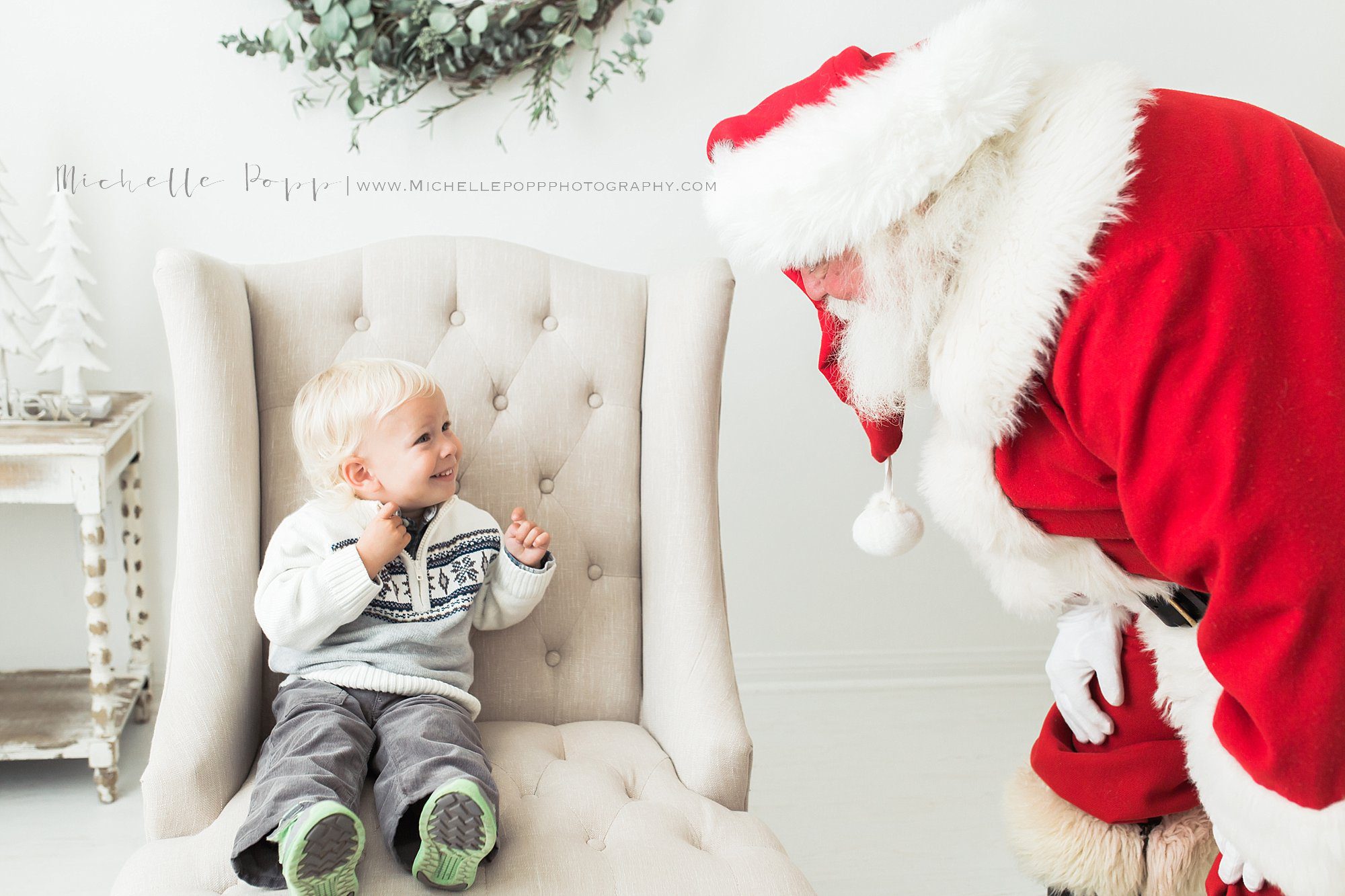little boy on chair excited to meet Santa