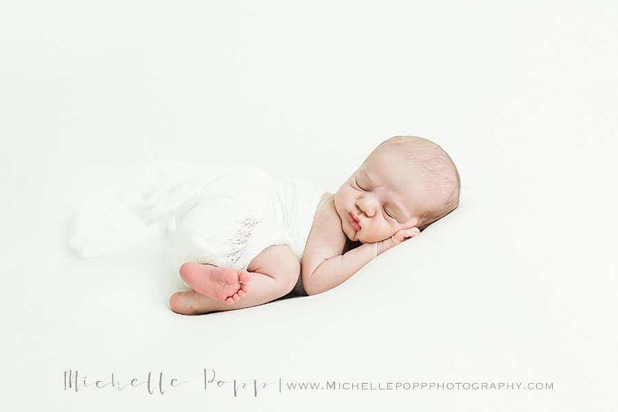 newborn baby on his tummy