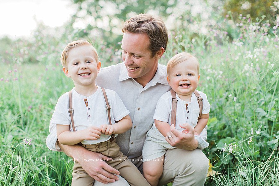 smiling father and children during family portrait session