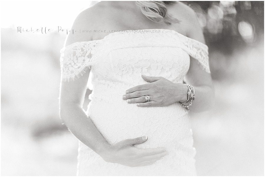black and white picture of a pregnant mother during her maternity photo shoot