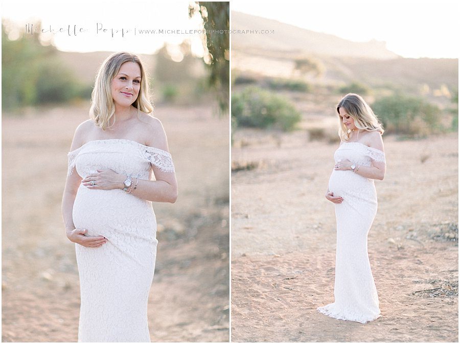 a smiling mother looks at the camera during her maternity photo shoot in San Diego