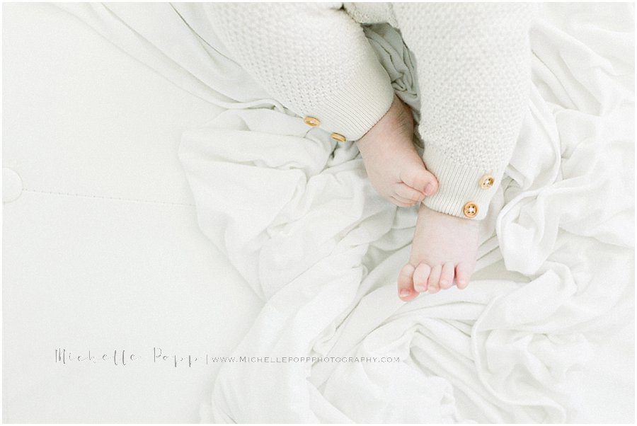 pictures of a baby's feet in bed sheets