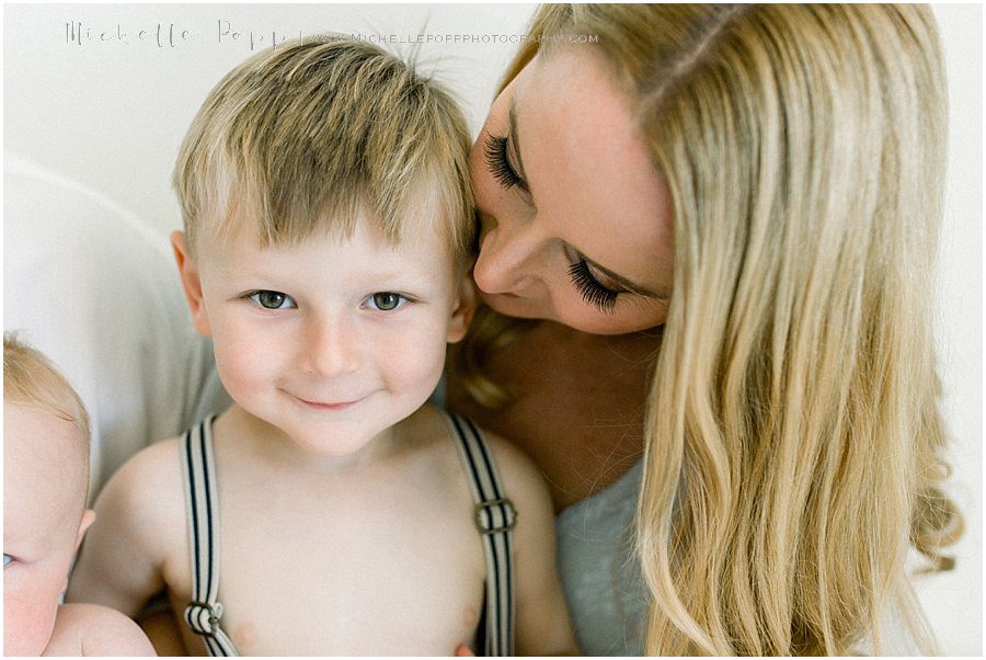 mother smiling and hugging her young son during a family photography session