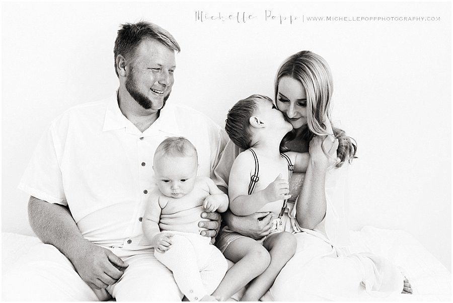 black and white image of a happy family during a natural baby photography session in San Diego