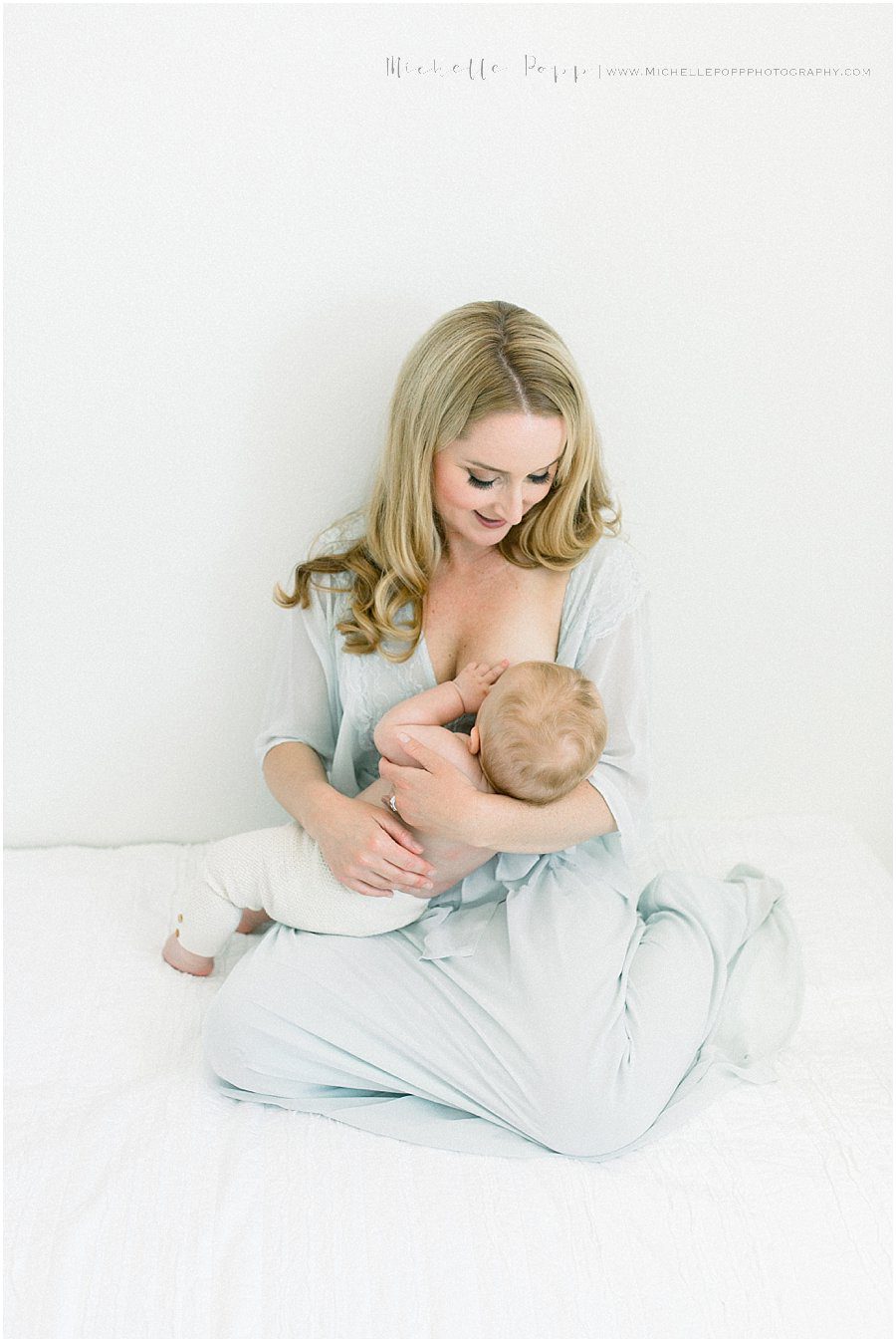 loving and caring mother breastfeeding her young baby during a natural baby photography session
