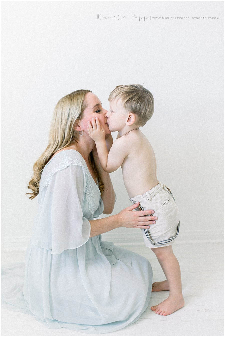 mother kissing her son during a family photography session