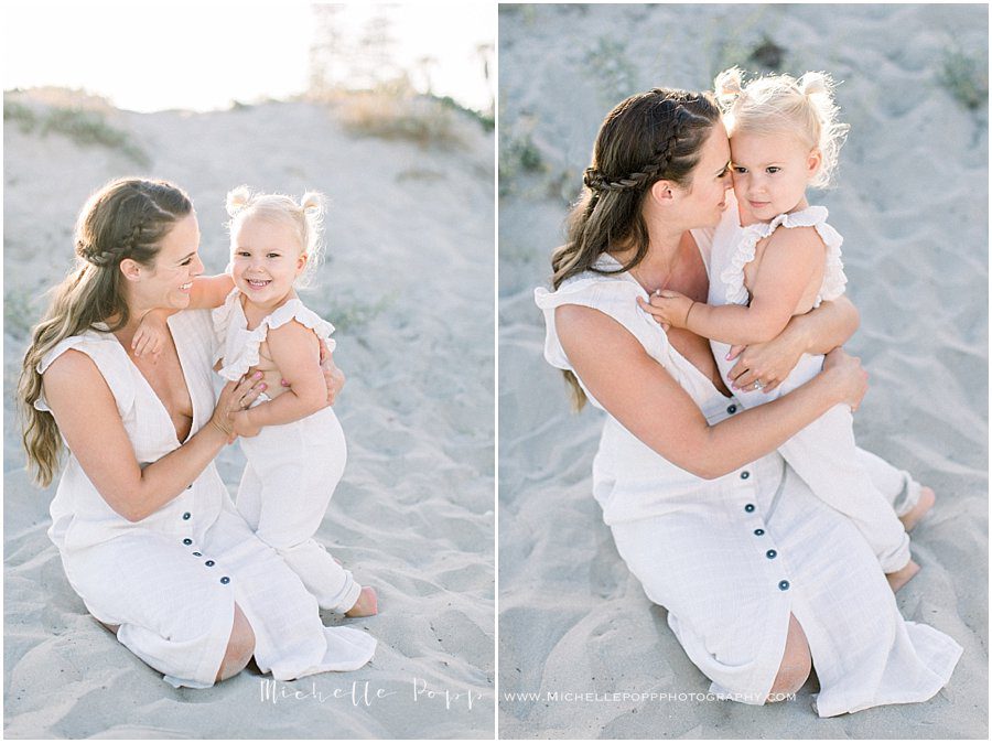 pictures of a smiling mother and her young daughter taken by a family beach photographer