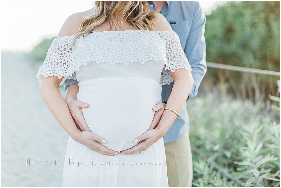 picture of a couple holding the baby bump during a maternity photography session