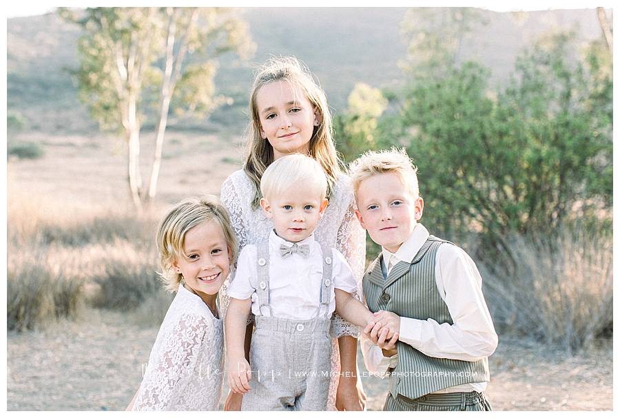 two boys and two girls sibings smiling at camera