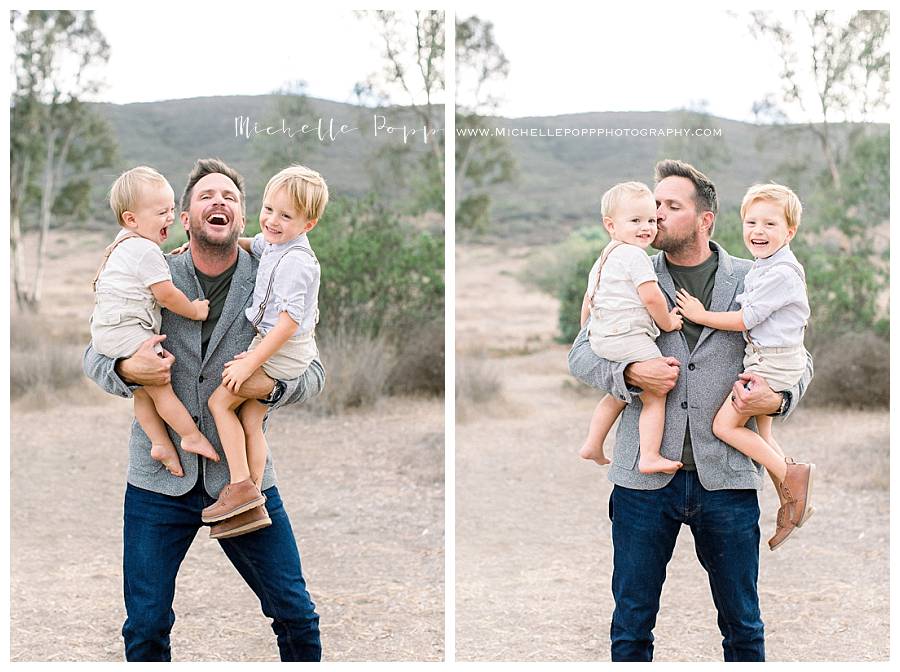 dad holding baby boys in arms 