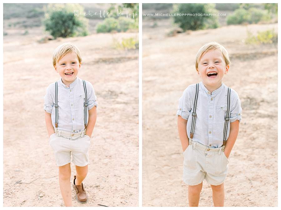 little boy laughing with hands in his pockets
