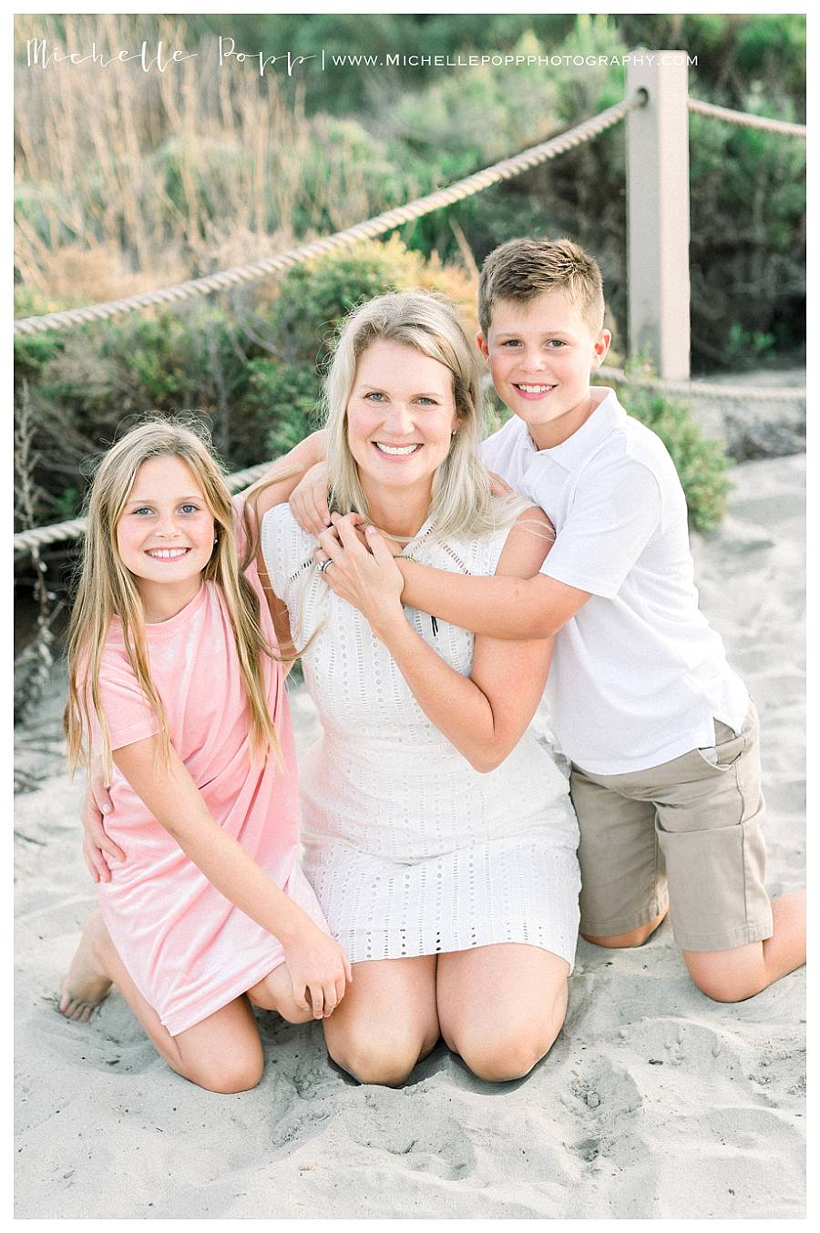 mom and two kids smiling at camera