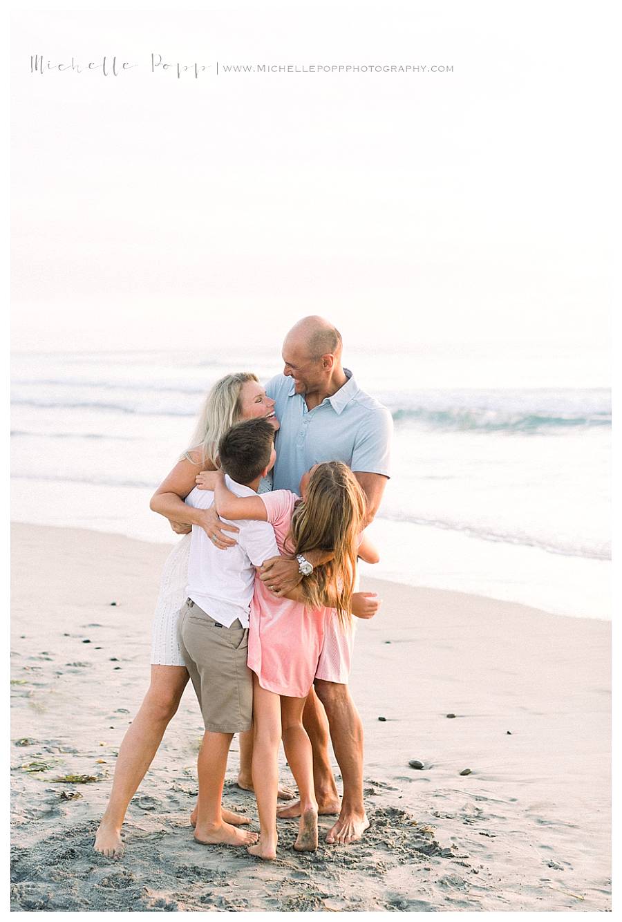 family of four in group hug