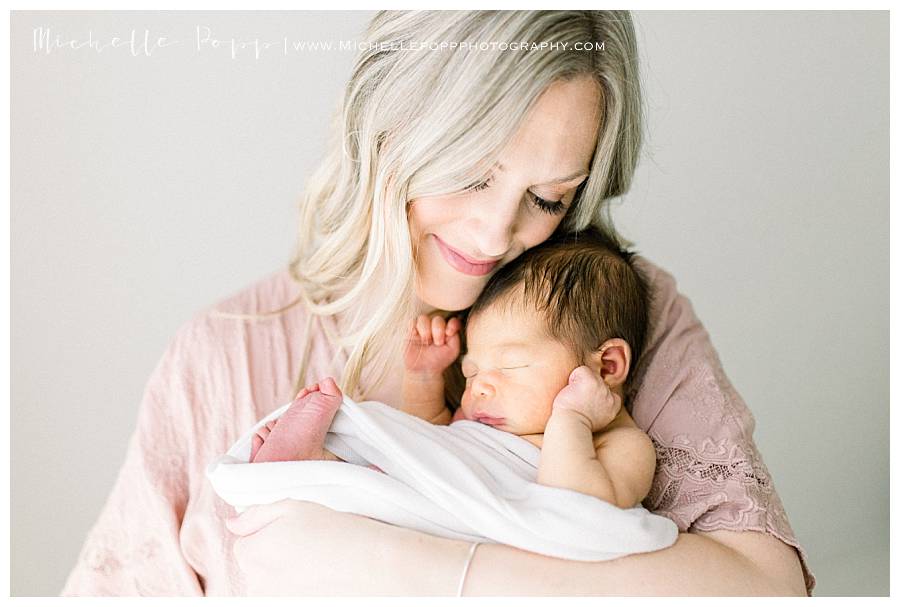 woman holding newborn baby boy