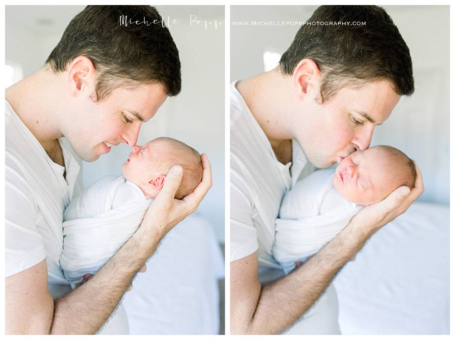 dad holding baby girl newborn