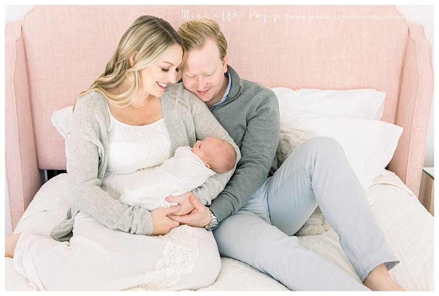 parents looking down at baby