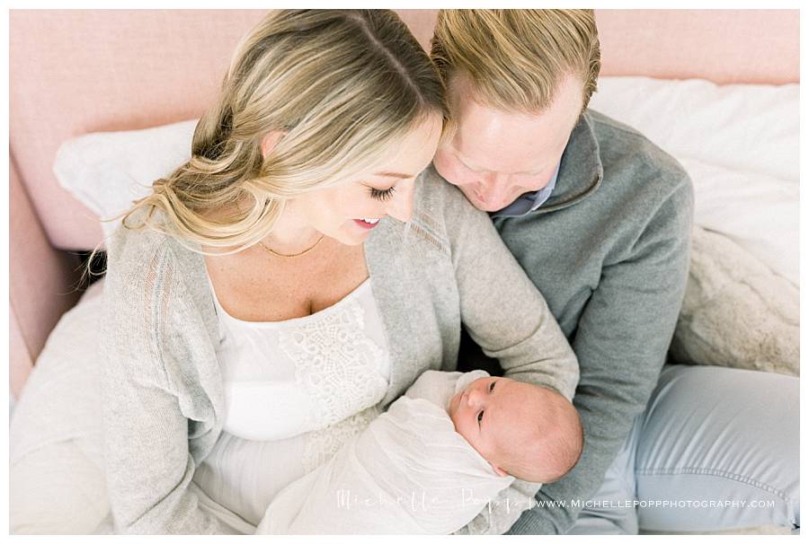 happy parents looking down at baby