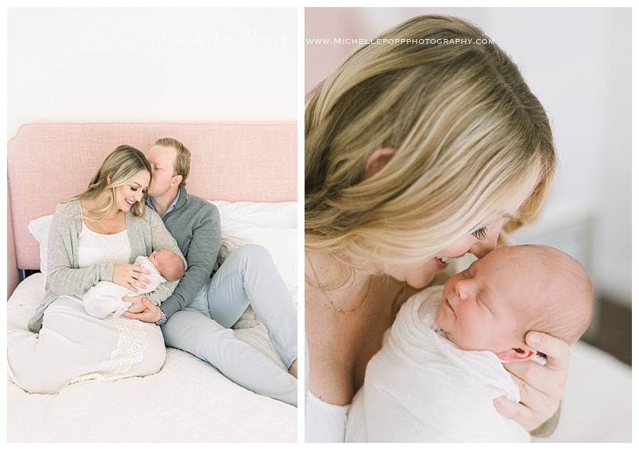 mom and dad holding newborn baby on bed