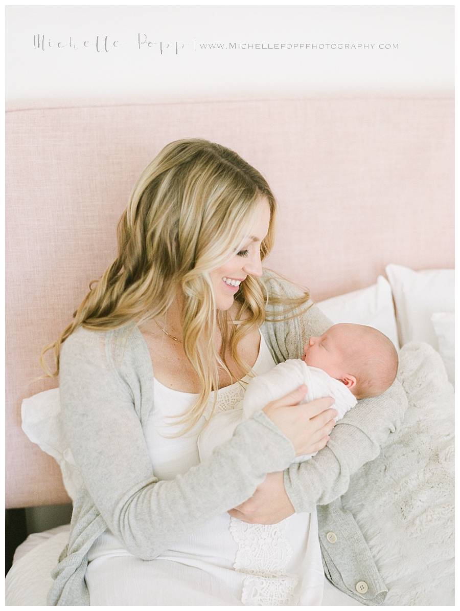 mom smiling happily down at baby