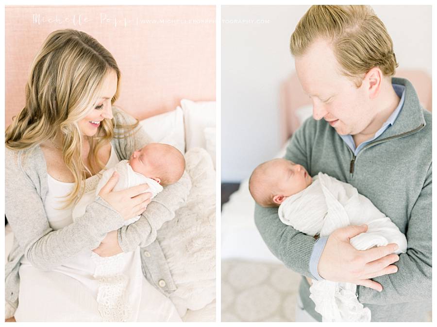 dad and mom holding baby and smiling