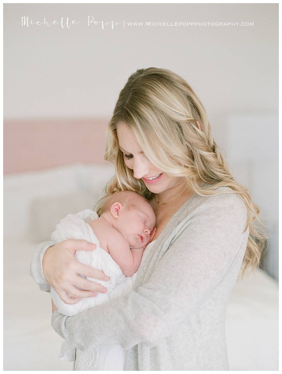 happy mom holding newborn