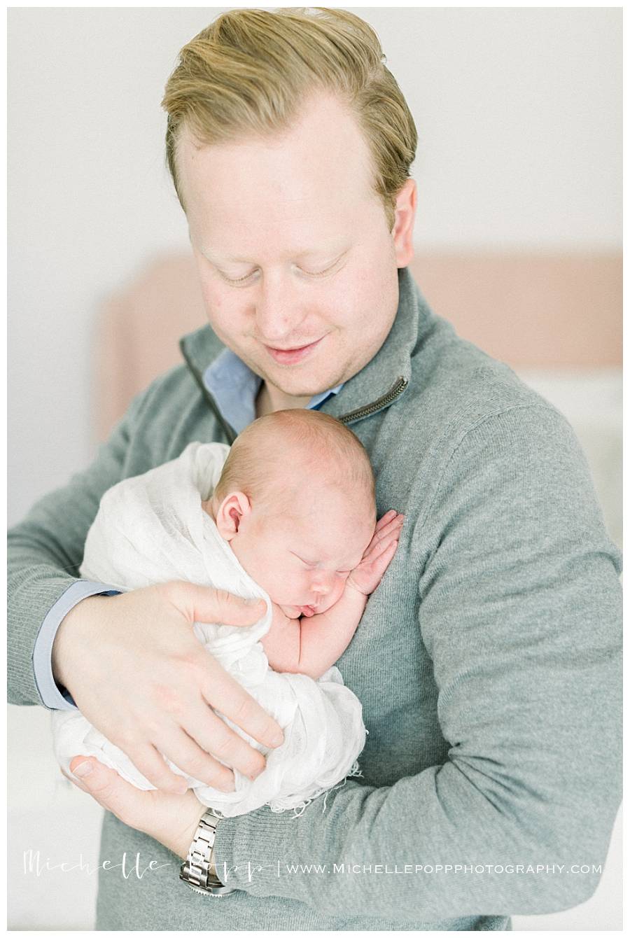 dad holding newborn baby girl