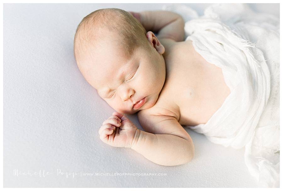 sleeping newborn on bed