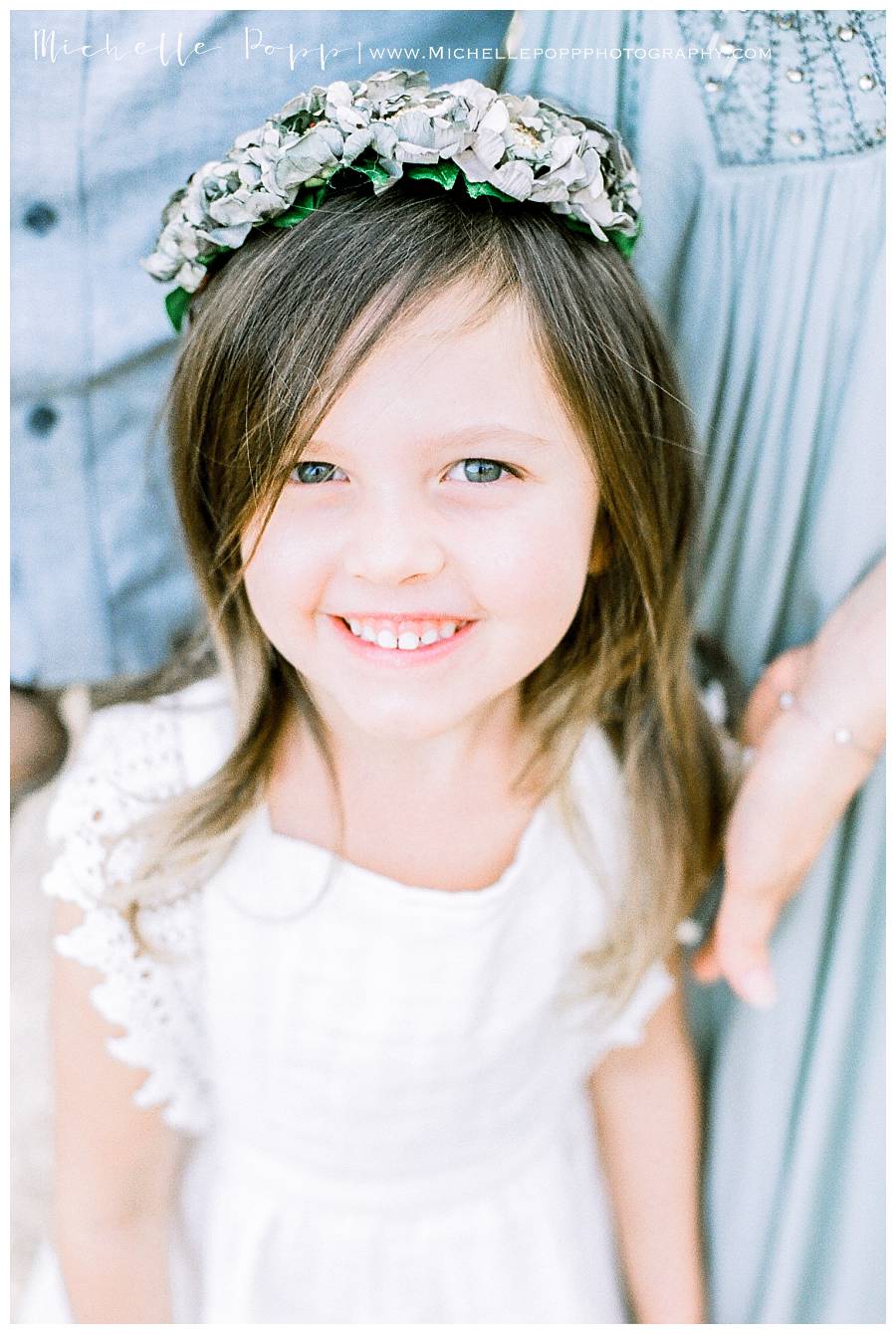 girl in white dress smiling at camera