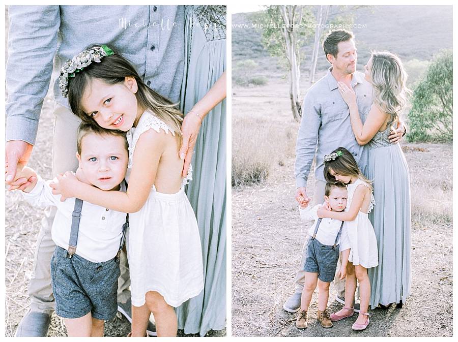 family of 4 smiling looking at camera