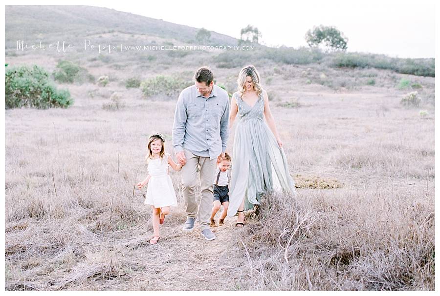 family of four walking in a field