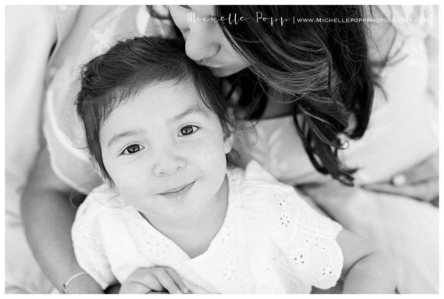 black and white of little girl smiling at camera