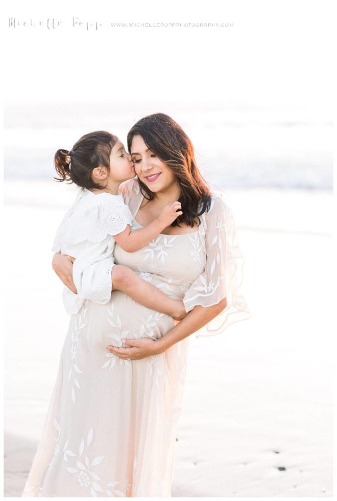 mom holding girl and smiling